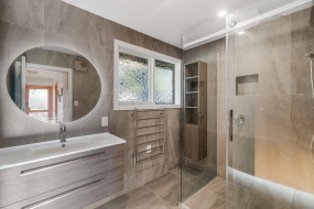 modern bathroom renovation gray tiles glass shower round mirror2