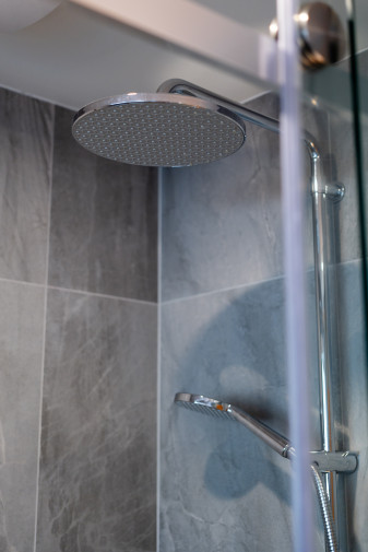 modern bathroom renovation gray tiles glass shower round mirror3